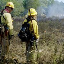 Davis and female with drip torch-293x212